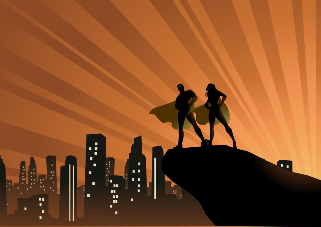 A silhouette style vector illustration of a couple of superheroes standing on a cliff with city skyline and sunburst in the background
